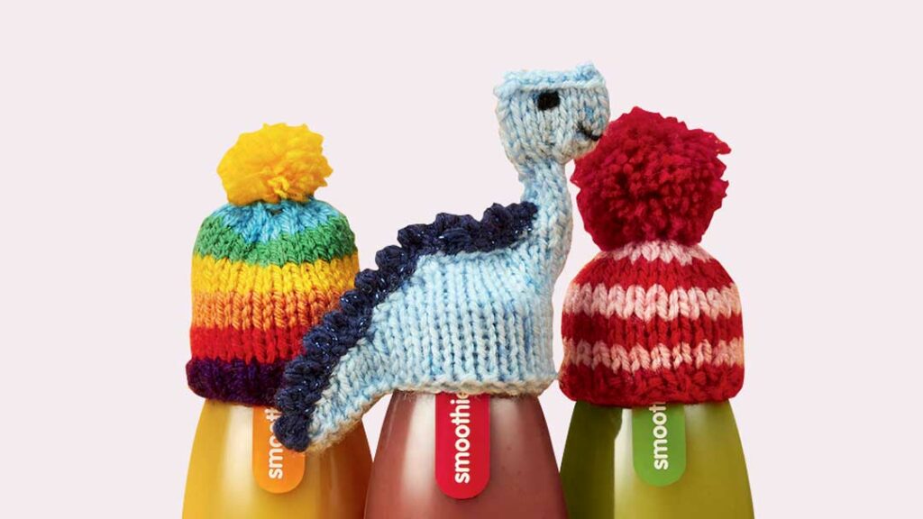 Trois bouteilles de smoothie Innocent recouvert de leur bonnet tricoté